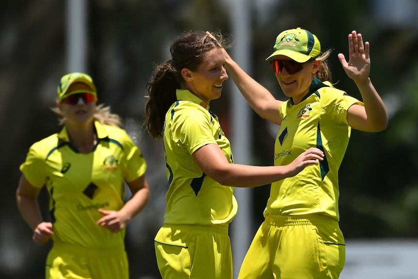 Darcie Brown and Annabel Sutherland hug after a wicket during Australia's ODI against Pakistan.