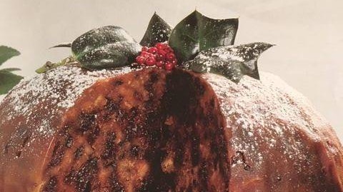 Christmas Pudding on a glass stand with holy on top