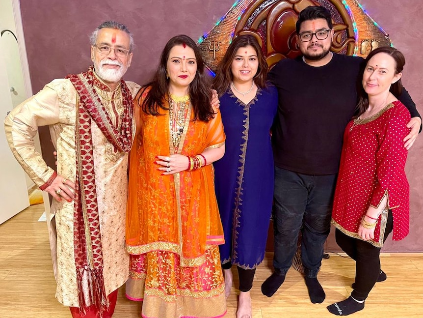 A family wear traditional Indian clothes on Diwali.