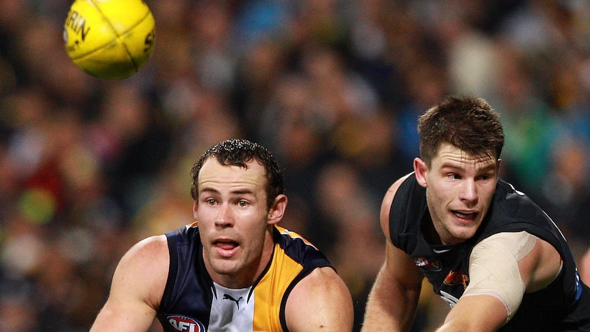 Shannon Hurn of the West Coast Eagles handballs against Carlton.