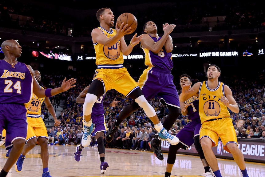Golden State Warriors' Steph Curry shoots over the LA Lakers' Jordan Clarkson in November 24, 2015.