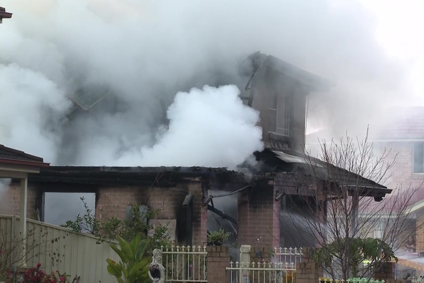 Smoke billows from a burning house