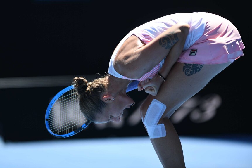 Karolina Pliskova is doubled over, screaming at the ground in joy while playing against Serena Williams at the Australian Open.