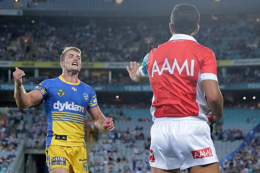 Referee Matt Cecchin speaks to Parramatta's Kieran Foran during match at the Olympic stadium