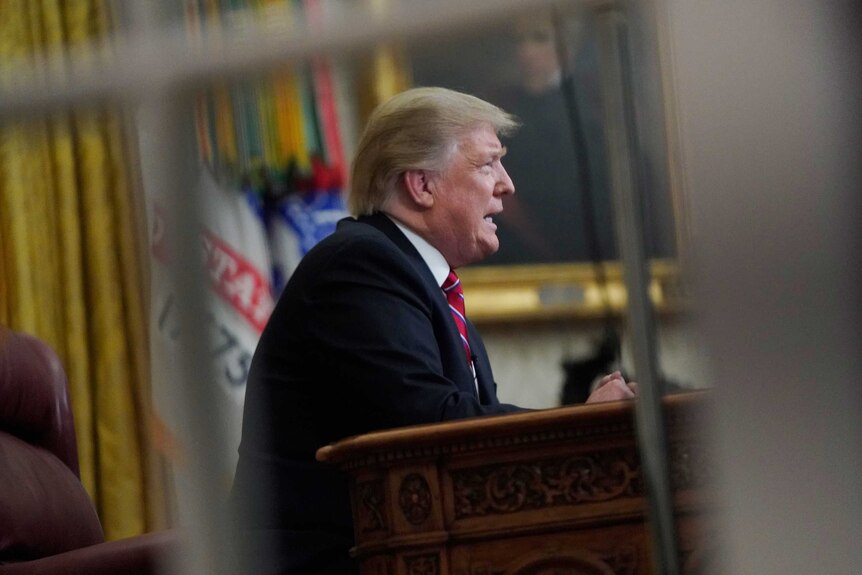 US President Donald Trump addresses the nation from the Oval Office.