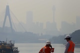 Construction workers are seen as smoke haze drifts over the CBD in Sydney in October.