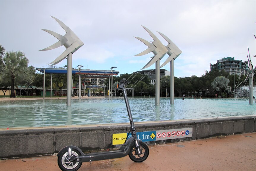 A scooter next to the laggon on the Cairns Esplanade 