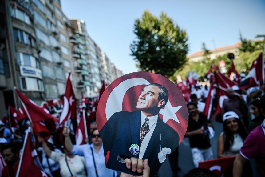 Demonstrator holds a poster of Mustafa Kemal Ataturk