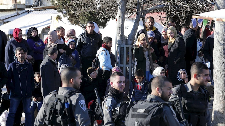 Israeli border policemen stand guard at the scene.