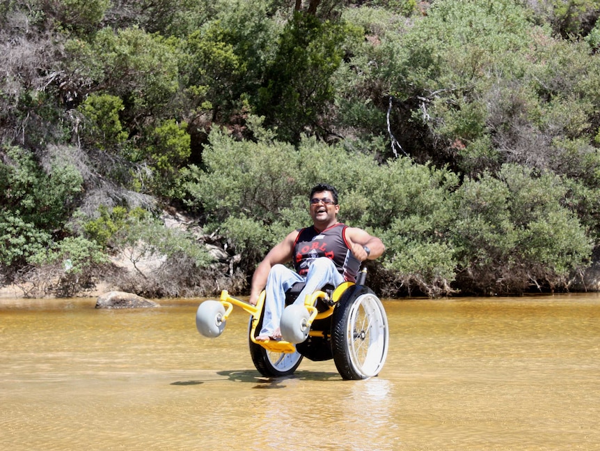 Judeland Anthony using a beach wheelchair
