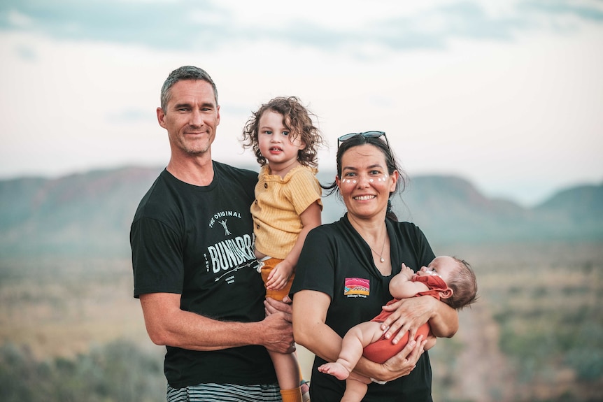 A man and woman with a toddler and baby.