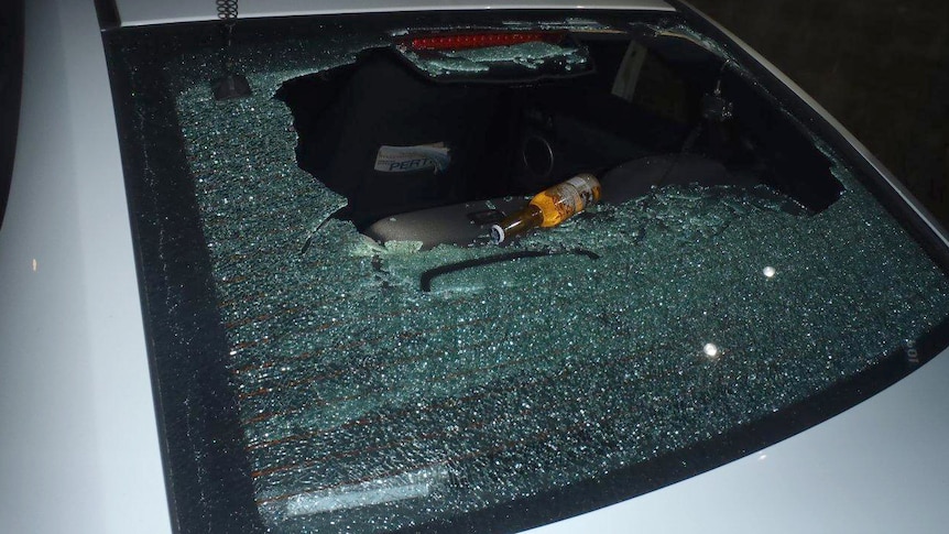 Police car rear window smashed at out of control party party in Balga