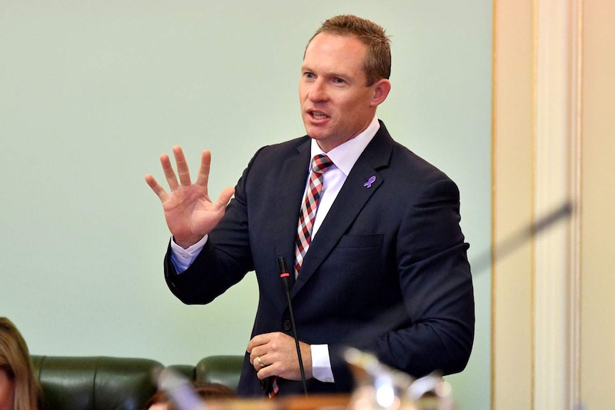 Housing Minister Mick de Brenni gestures while speaking during Question Time at Queensland Parliament House.