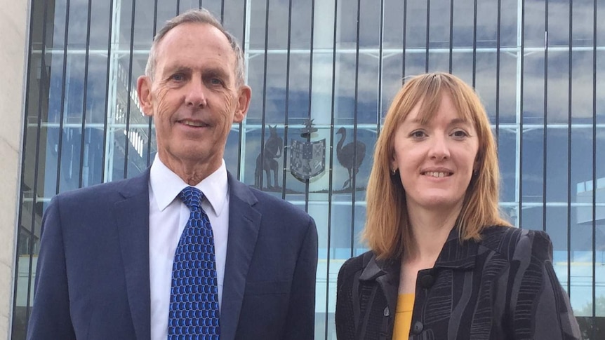 Bob Brown and Jessica Hoyt have their photograph taken outside the High Court in Canberra.