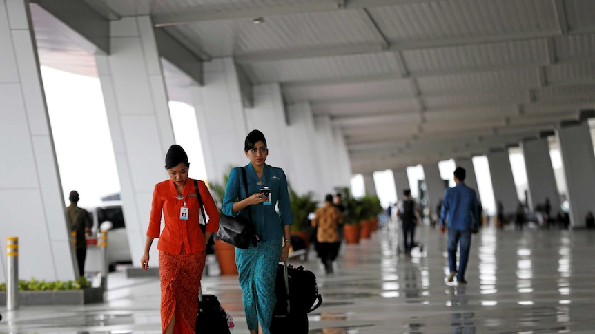 Garuda Indonesia flight attendants arrive at Soekarno-Hatta Airport in Jakarta, Indonesia