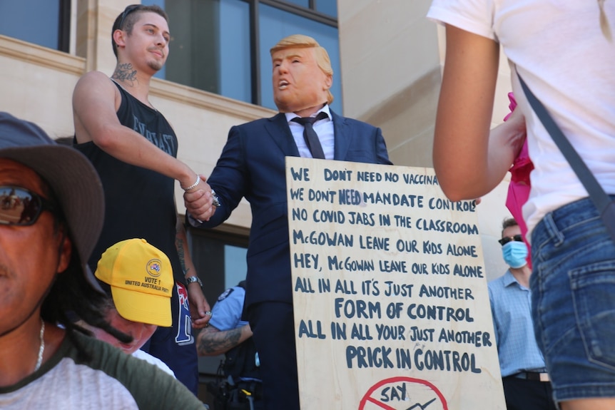 A Trump mask and anti-mandate sign at WA Parliament protest