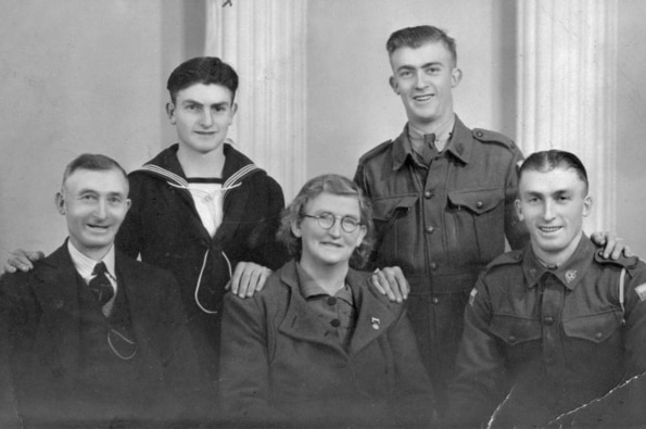 A black and white photo of Teddy Sheean and family members.