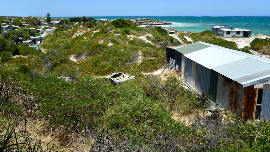a corrugated  iron shack with a beautiful view of the ocean
