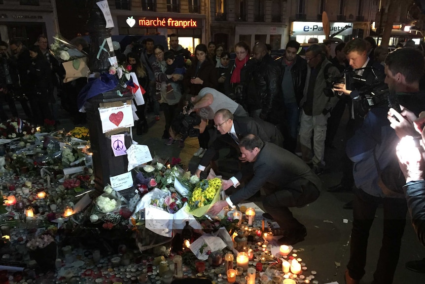 Josh frydenberg laying wreath near Bataclan club with Australian ambassador Stephen Brady