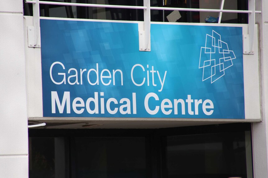 A tight shot of a blue sign for Garden City Medical Centre.
