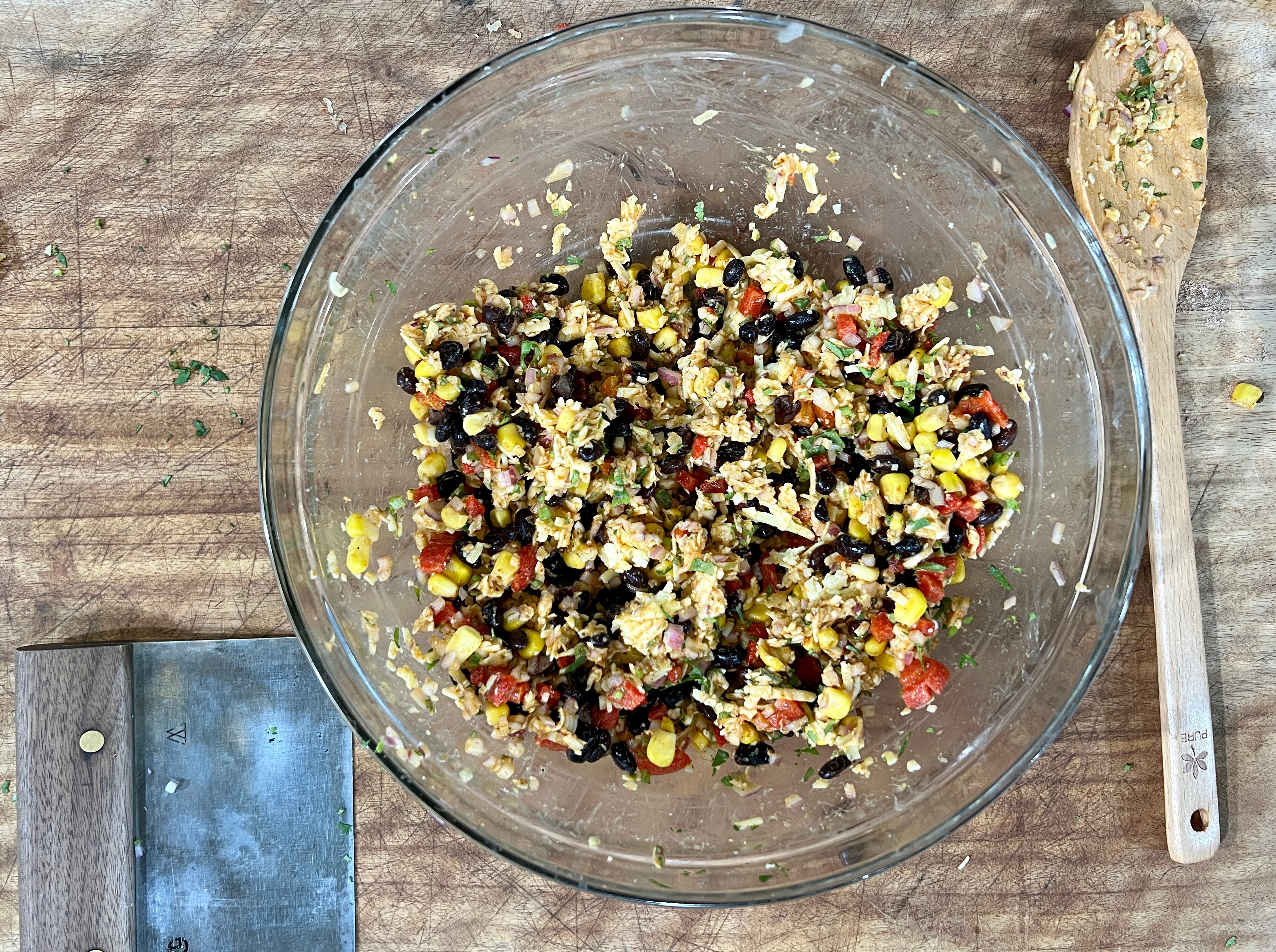 Enchilada mix in a mixing bowl on bench top ready to fill tortilla