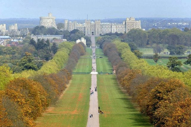 Visitors walk in Windsor Great Park in front of Windsor Castle