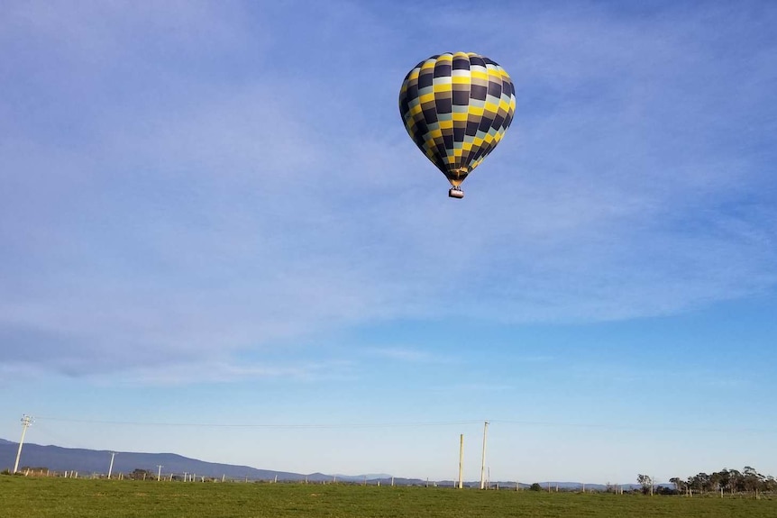 Hot air balloon airborne over Tasmania.