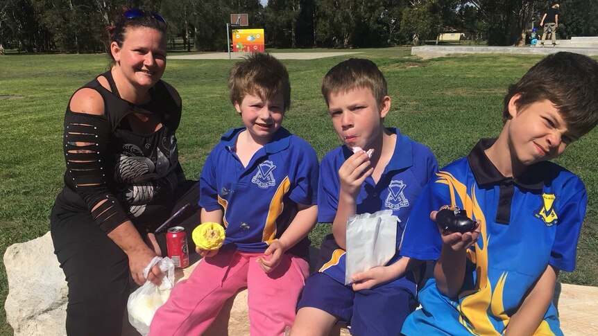 Suzie short sits at a park with her three primary school aged boys