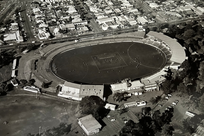 An aerial black and white photo of a large sports stadium