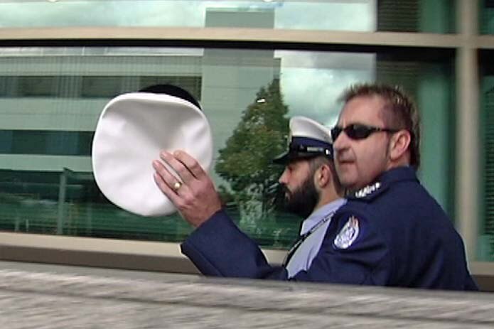 Prison guard Jake Hitchens (with beard) leaves Hobart Magistrates Court