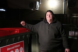 Tracey Phillips leans on a large bin.