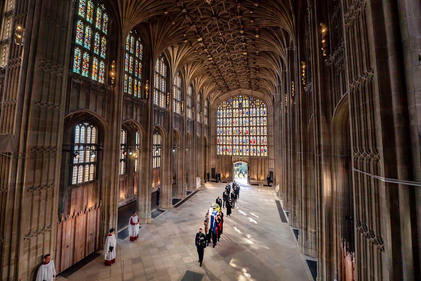 From above, you look down at a sparse gothic hall with the coffin of Prince Philip.