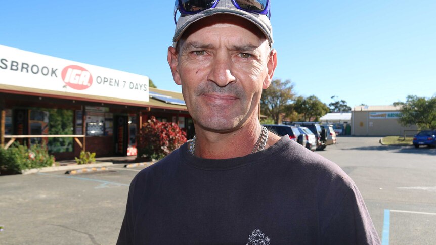 A tight head and shoulders shot of Bullsbrook resident Dean Dixon wearing a cap standing outside an IGA store.