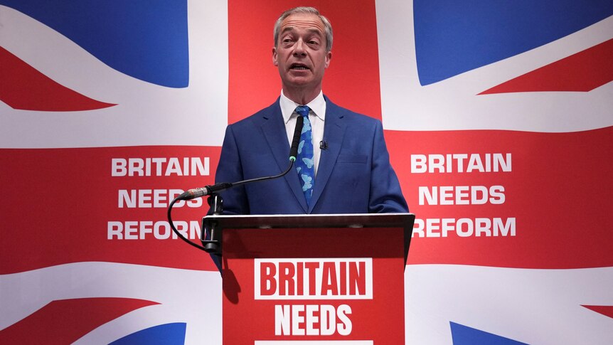 A man in a suit stands behind the union jack which reads Britain needs reform 