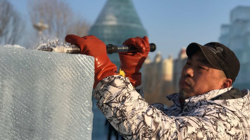 Ice sculptor Gao Kalin works on a replica of Moscow's Saint Basil Cathedral.