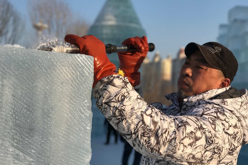 Ice sculptor Gao Kalin works on a replica of Moscow's Saint Basil Cathedral.