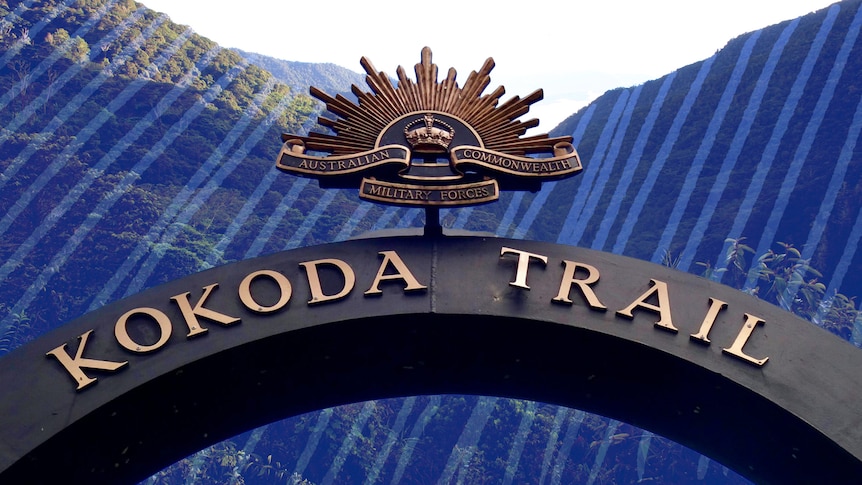 The Kokoda Trail arch sign with Rising Sun symbol above. The tropical mountains of Papua New Guinea in the background.