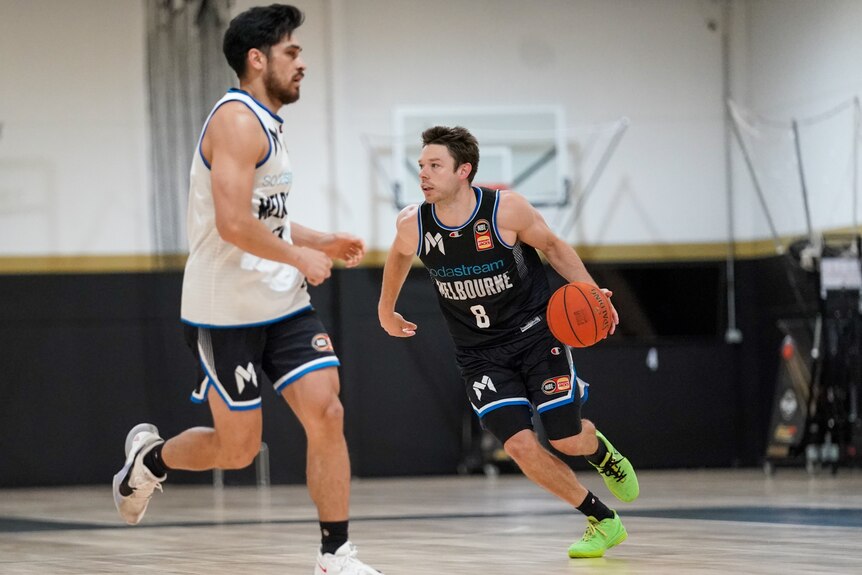 A Melbourne United NBL player dribbles the ball at a training session.