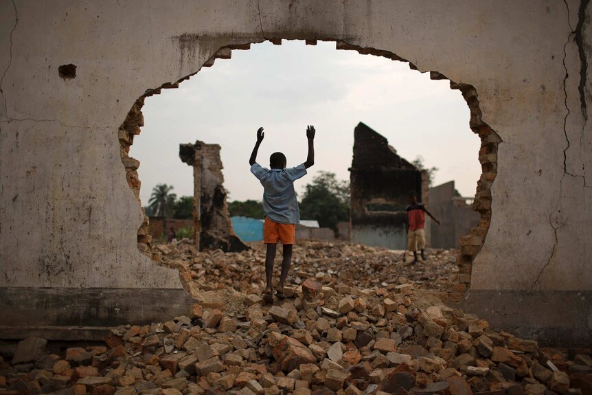 A boy plays among the ruins of a mosque in Bangui