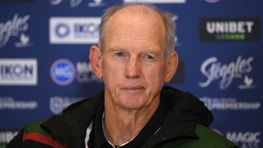 An NRL coach stares out at reporters at a post-match press conference.