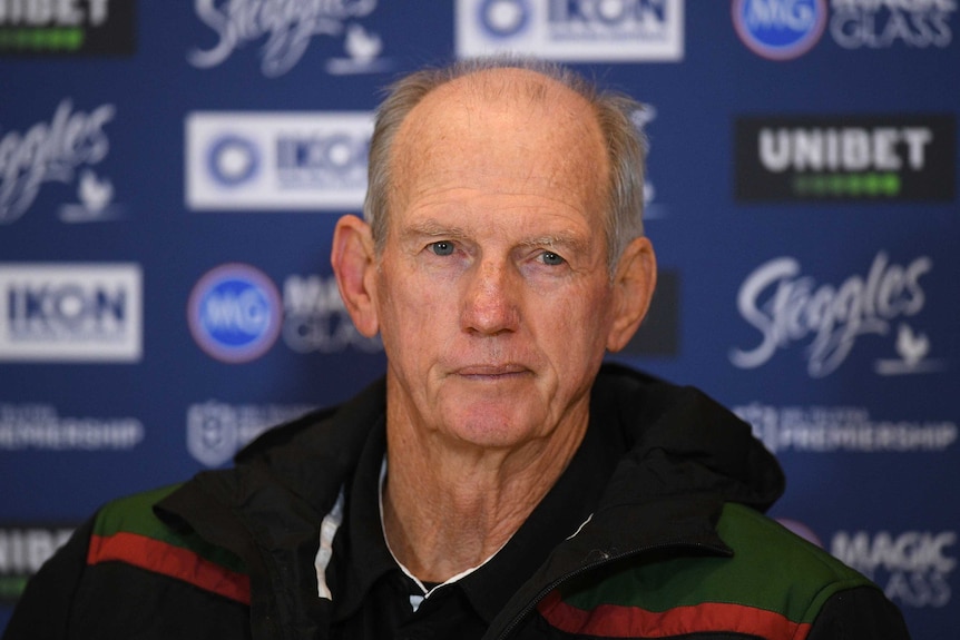 An NRL coach stares out at reporters at a post-match press conference.