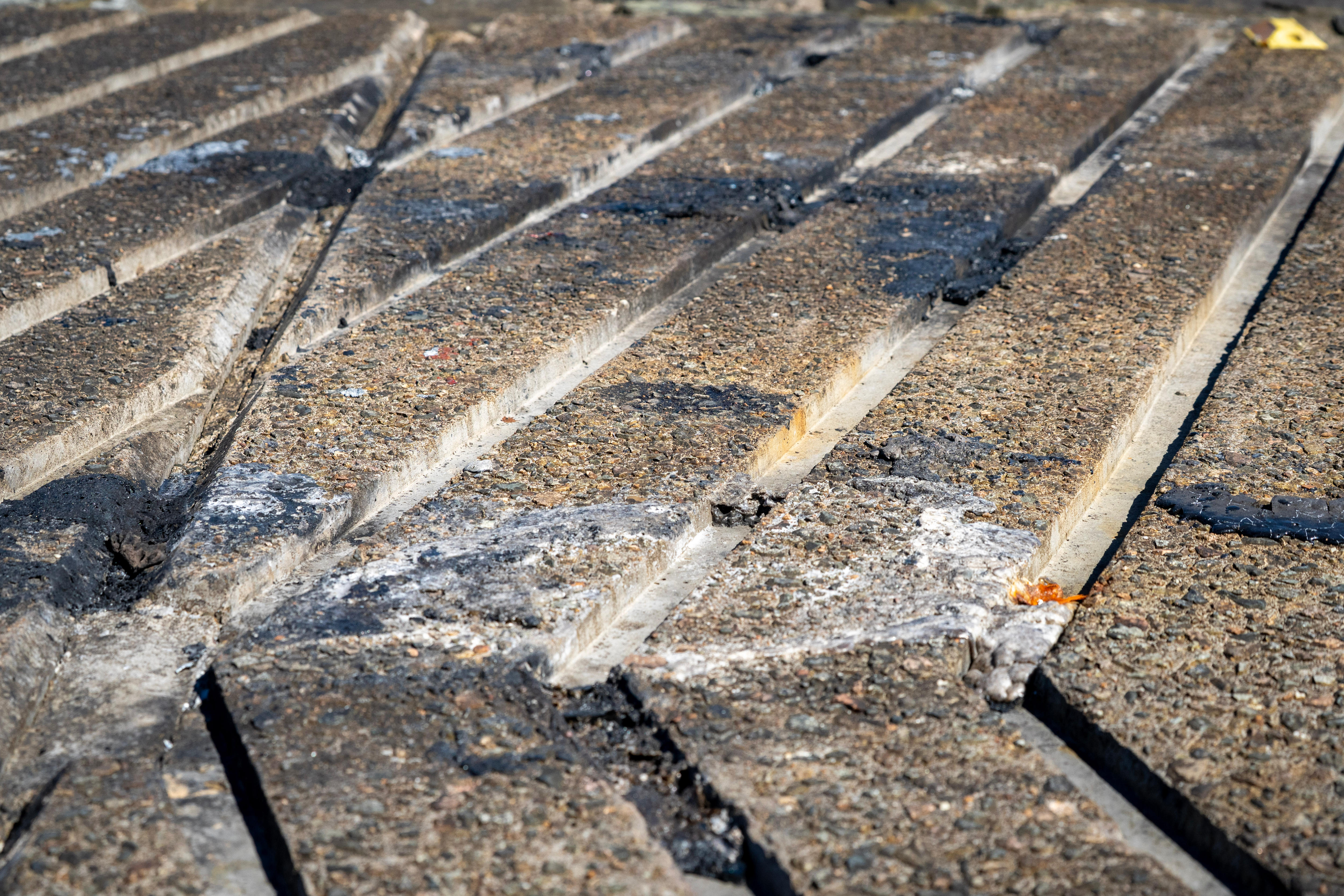 Dark patches of burnt rubber on concrete.