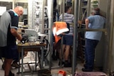 Telstra workers repair damaged telephone exchange at Warrnambool