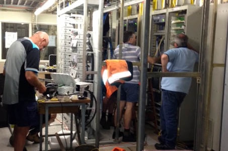 Telstra workers repair damaged telephone exchange at Warrnambool