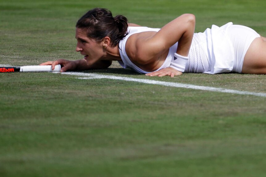 Andrea Petkovic lies on the turf at Wimbledon