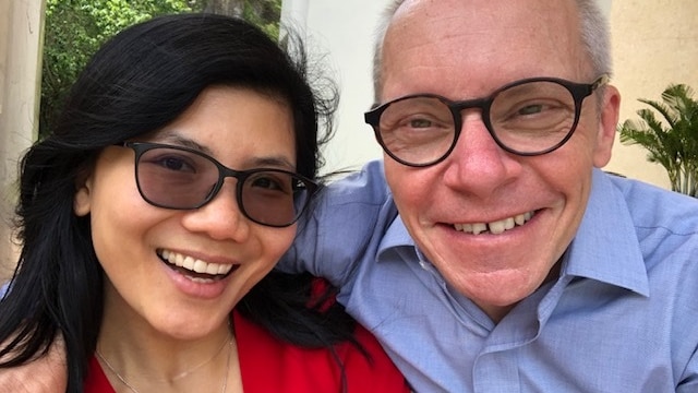 Dr Ha Vu and Professor Sean Turnell smiling for a photo together looking toward the camera