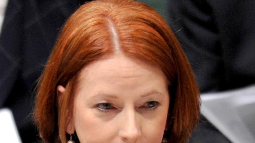 Prime Minister Julia Gillard listens during House of Representatives question time