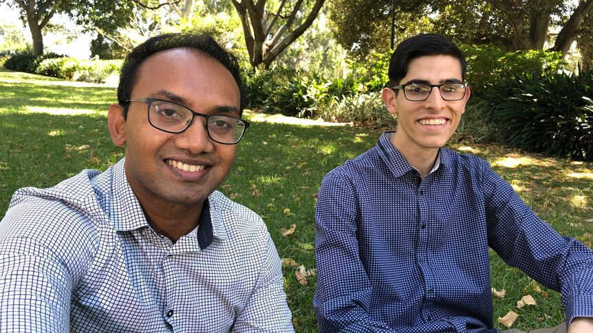 Surath Fernando and Nicolas Calandra sitting in a park. Interviewed by 7.30, February 2019