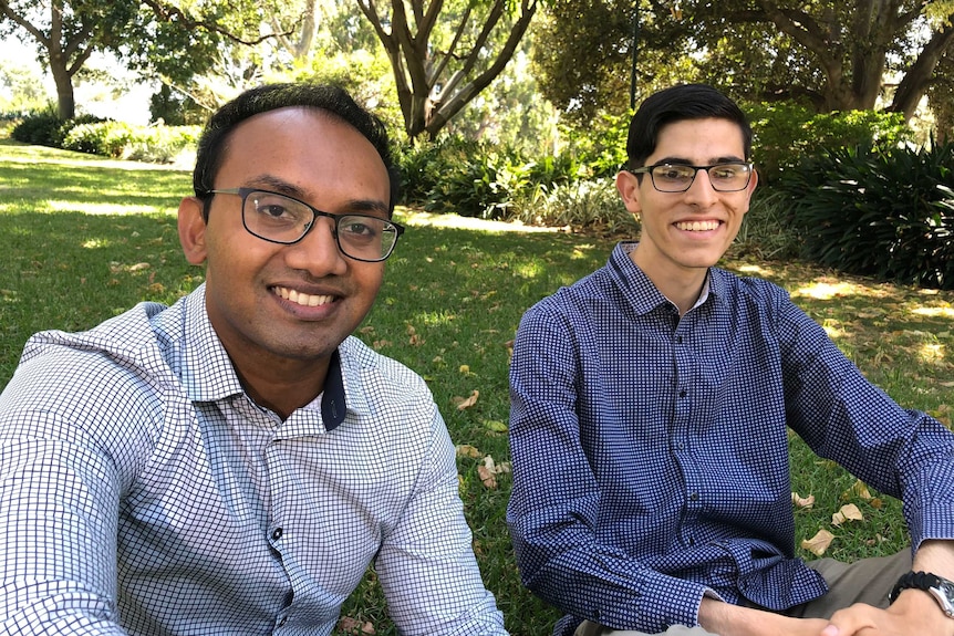 Surath Fernando and Nicolas Calandra sitting in a park. Interviewed by 7.30, February 2019