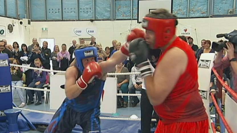 Tasmanian Liberal Leader Will Hodgman lands a punch on a radio announcer during a charity boxing match.